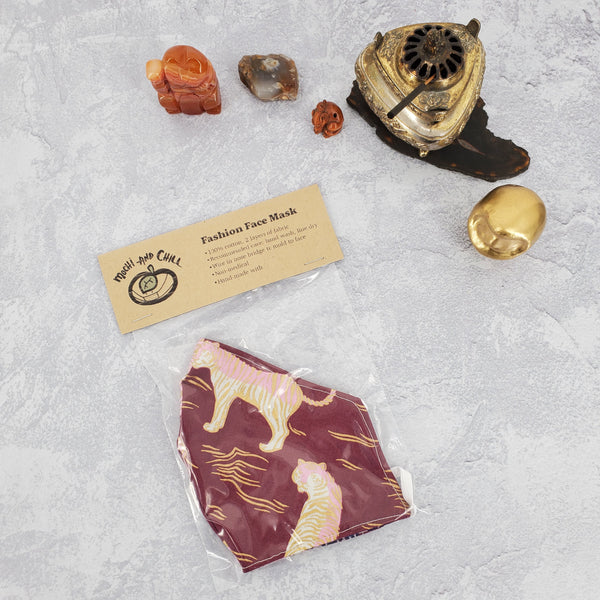 Photo of fitted face mask with burgundy background and tigers printed.