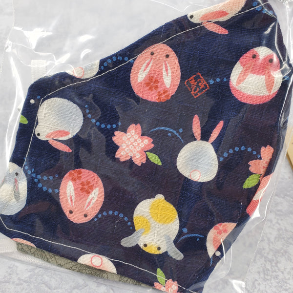 Close up photo of fabric with bunny pattern against dark blue background