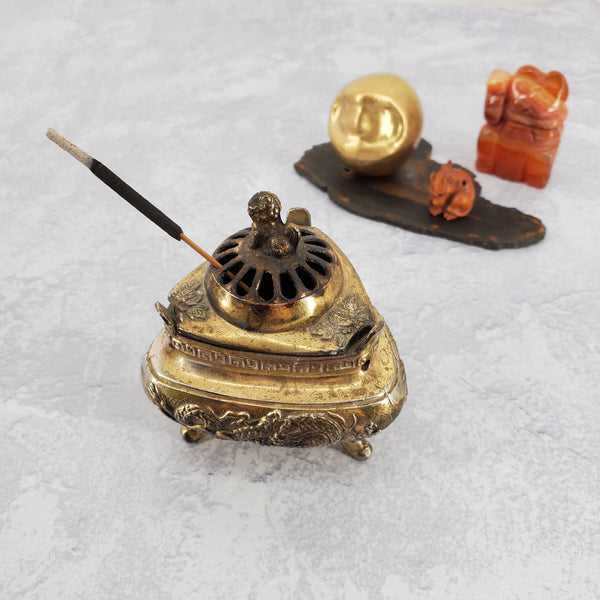 Photo of incense stick burning in a vintage incense holder