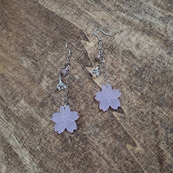 Photo of drop earrings with silver accents, floral bead and acrylic cherry blossoms at bottom