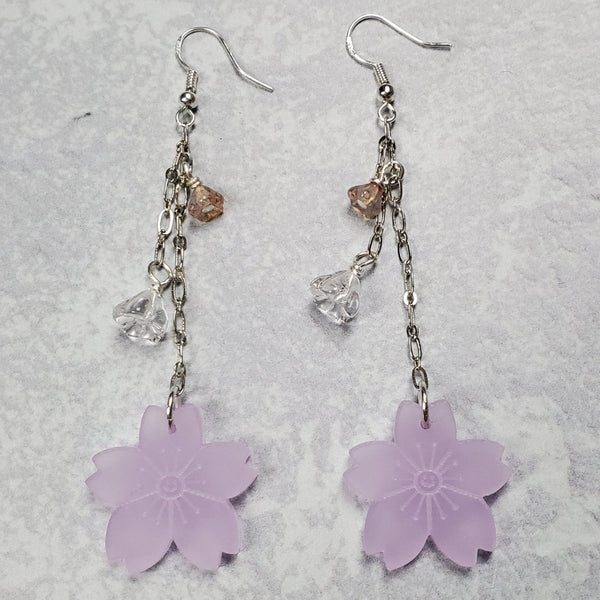 Photo of drop earrings with silver accents, floral bead and acrylic cherry blossoms at bottom