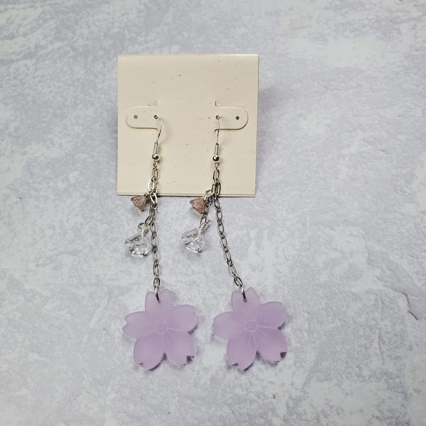 Photo of drop earrings with silver accents, floral bead and acrylic cherry blossoms at bottom